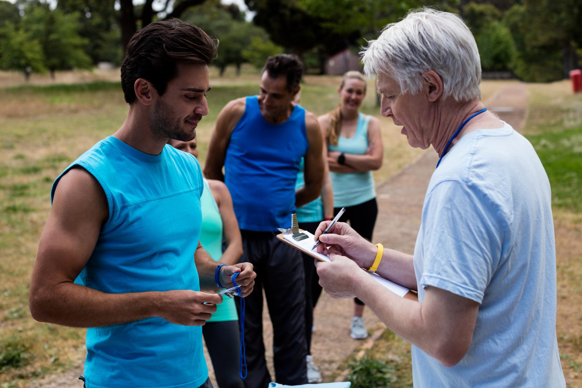 Volunteer registering athletes name for race in park